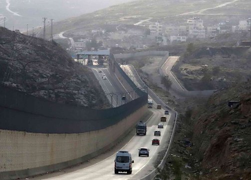 The “Apartheid Road,” where the Wall separates Israeli and Palestinian traffic