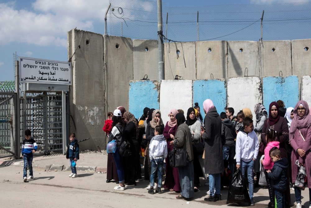 Palestinians queue to exit Qalandiya checkpoint, 2019