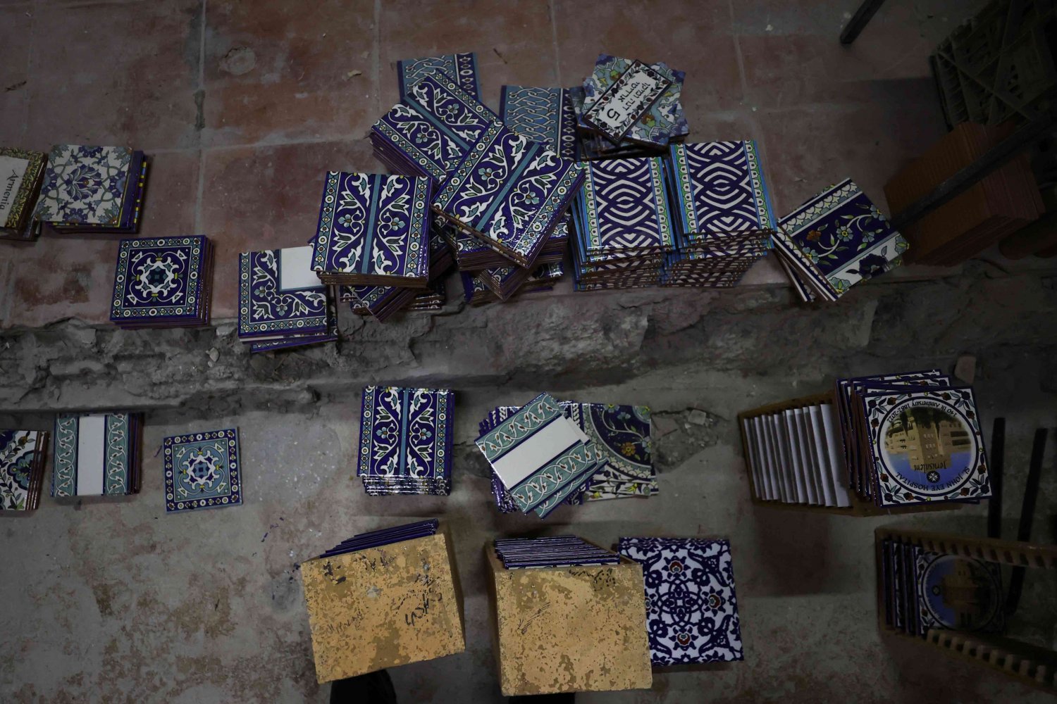 Ceramic tiles hand-painted with Arabesque designs are ready for packing at the Balian Armenian pottery workshop, Jerusalem 